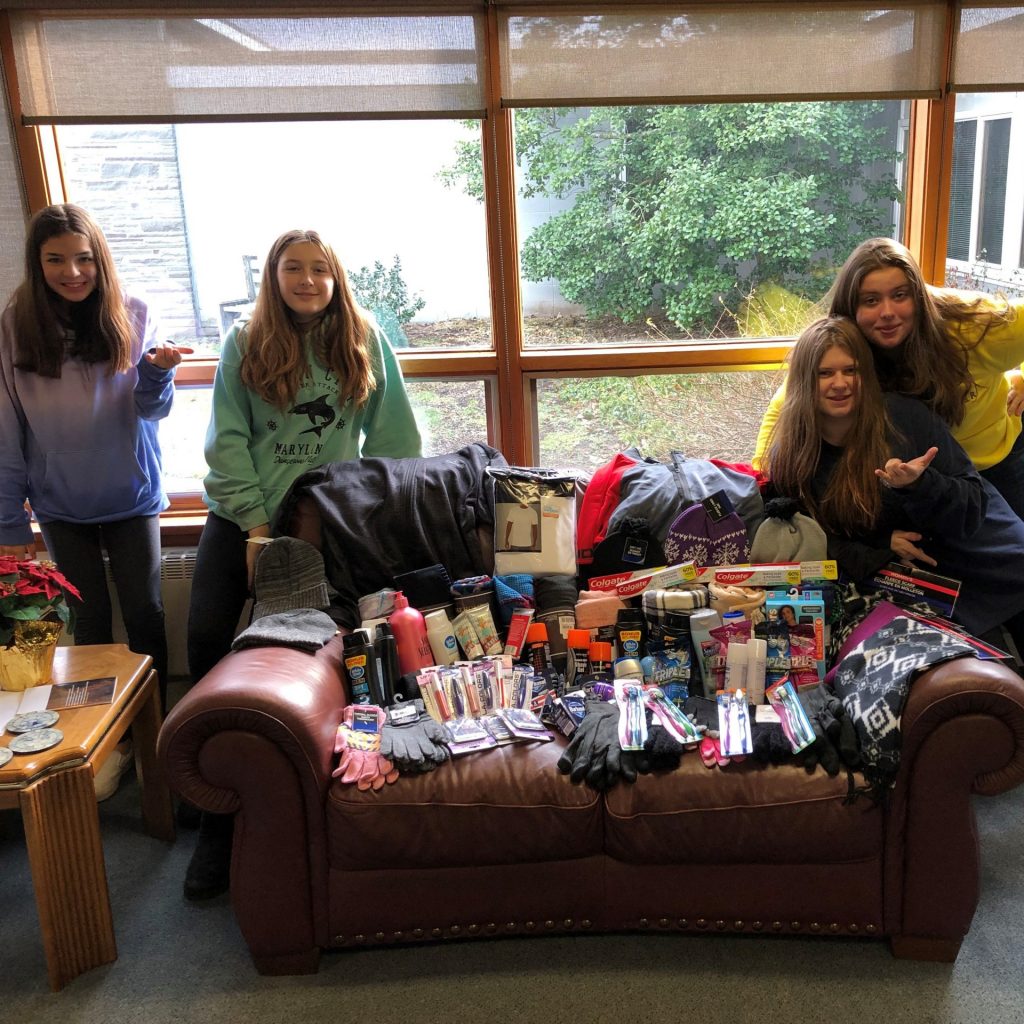 Girls sitting near a couch with love kits